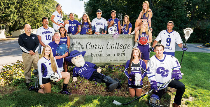 Curry College Coloneles representing all of the NCAA teams and Cheerleading pose for a photo at the front gate