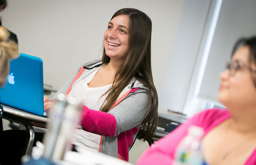 Curry College continuing education student in class pursuing a communication degree