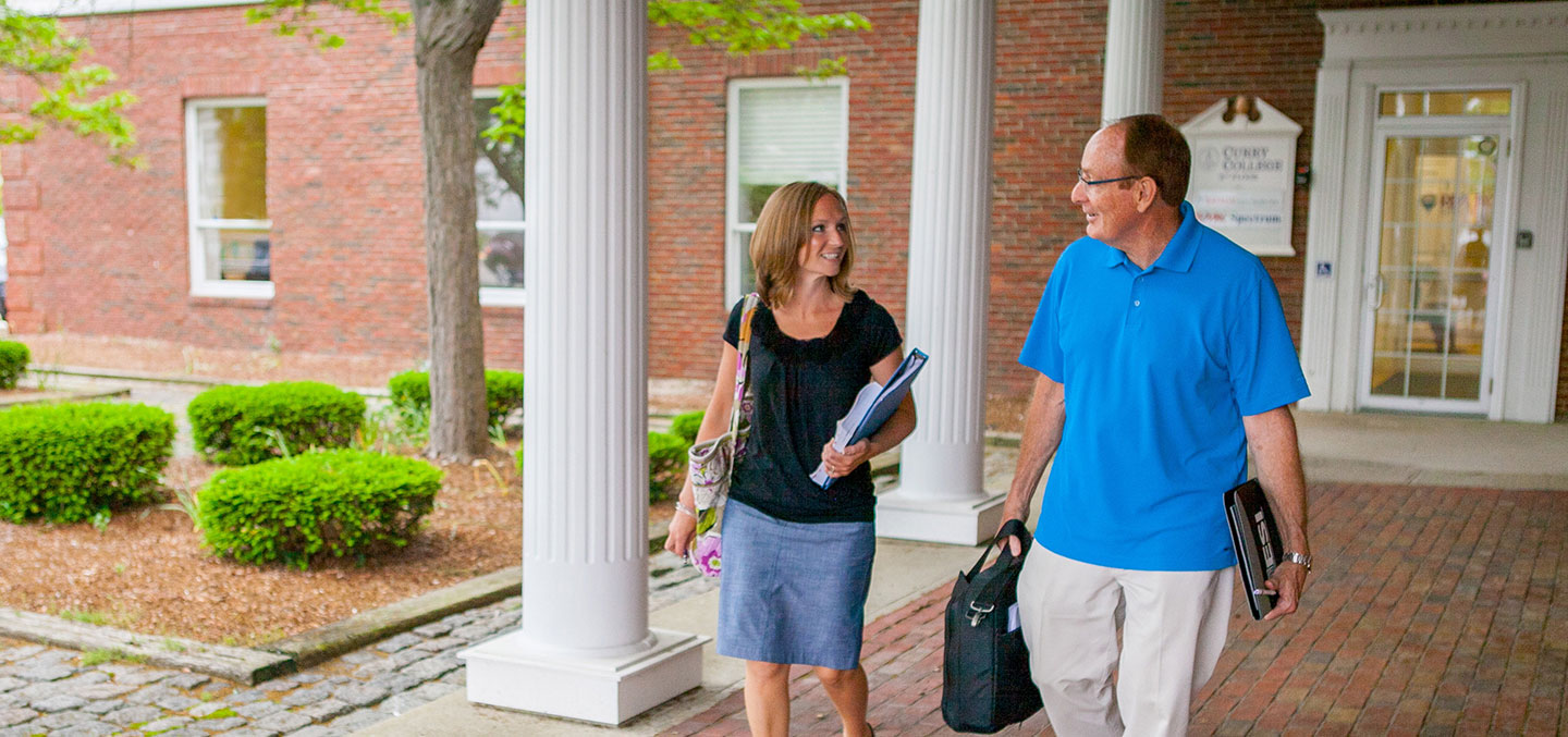 Two adult students walking to class at the Curry College Plymouth Campus