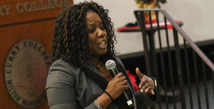 A Curry College Master of Busibness Administration (MBA) student speaks in class representing the Leadership Degree
