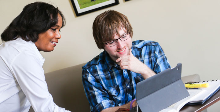 A Program for Advancement of Learning (PAL) student is assisted by a PAL faculty member