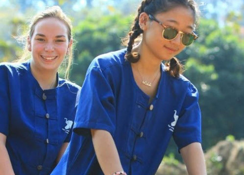 Michelle Jen '18, Curry College student riding an elephant in Thailand