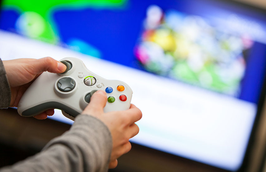 Student with a controller in the Video Game Studies concentration at Curry College