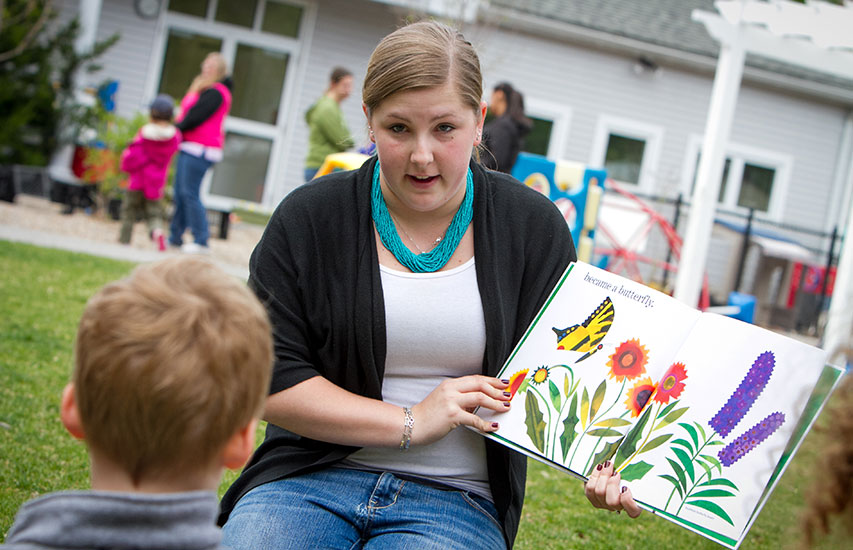 Student pursuing an Early Education and Care degree at Curry College teaches young children