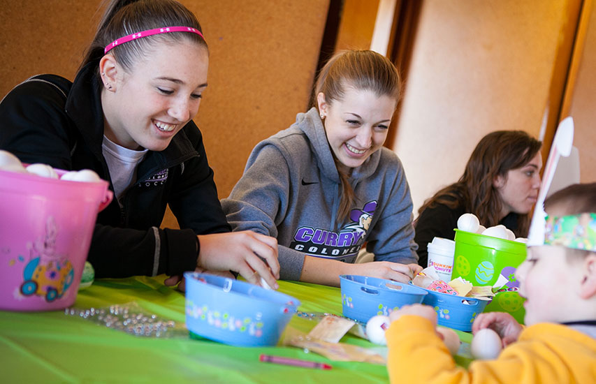 Curry College students pursuing an Out of School Time Education degree work with a young child