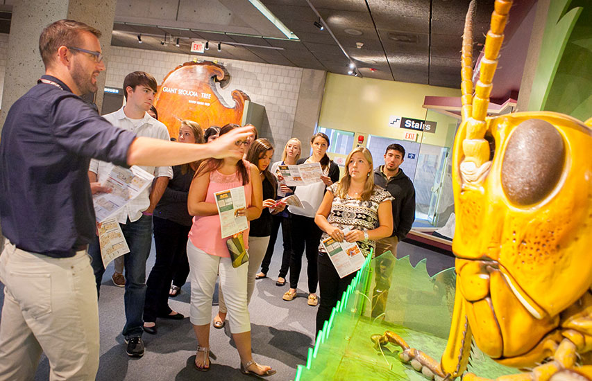 Curry College Students in the STEM Teaching Workshop listen to a speaker at the Museum of Science