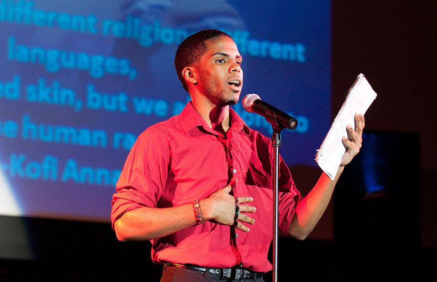 Student reads poetry on stage representing the Curry College English degree