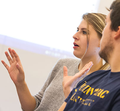 A Curry College Honors program student sparks conversation in the classroom