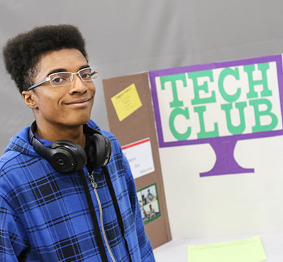 A Curry College Tech Club student at an involvement fair