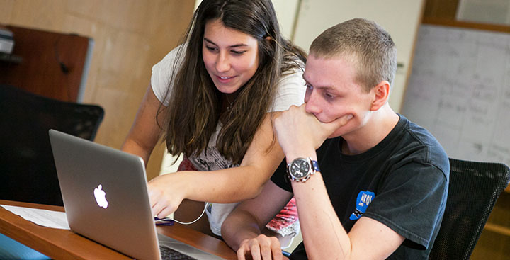 Two students apply to Curry College on their laptop