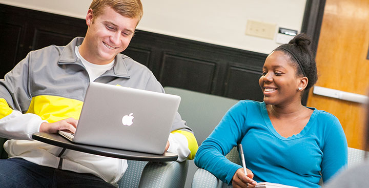 Two students apply to Curry College on their laptop