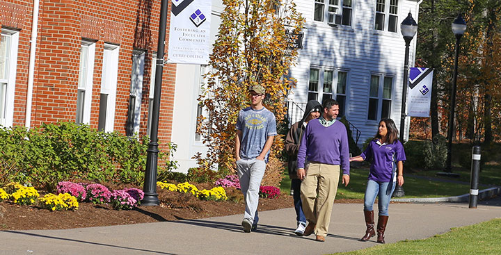 A Curry College Student Admission tour guide gives a tour to a family