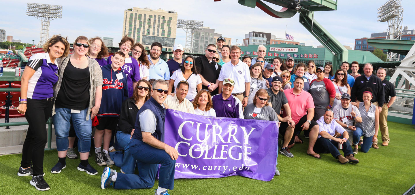Curry College Alumni events are represented by a group photo of a recent reunion at a Red Sox game at Fenway Park