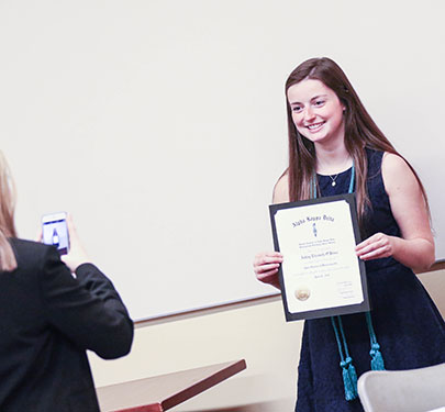 An Alpha Kappa Delta member at the induction ceremony