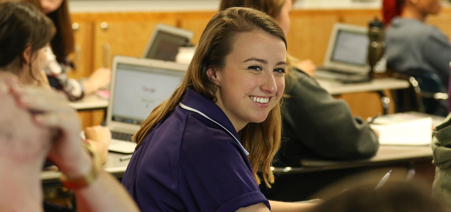 Female student smiling in a classroom