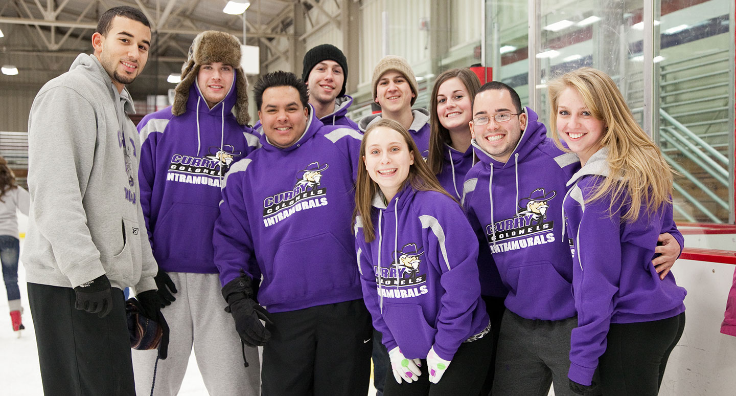 Curry students posing for a photo at the ice rink