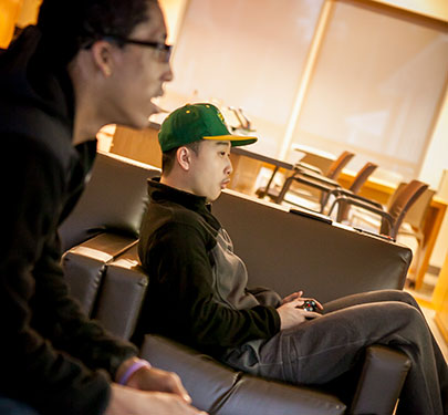 Two students playing a video game