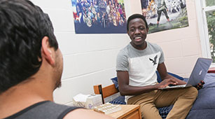 Alumni hug at Curry College Homecoming and Family Weekend event