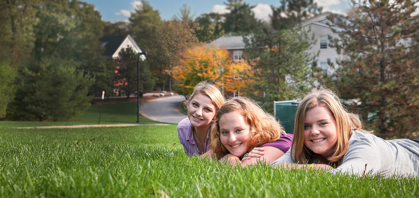 Students laying on the grass on the Curry College campus